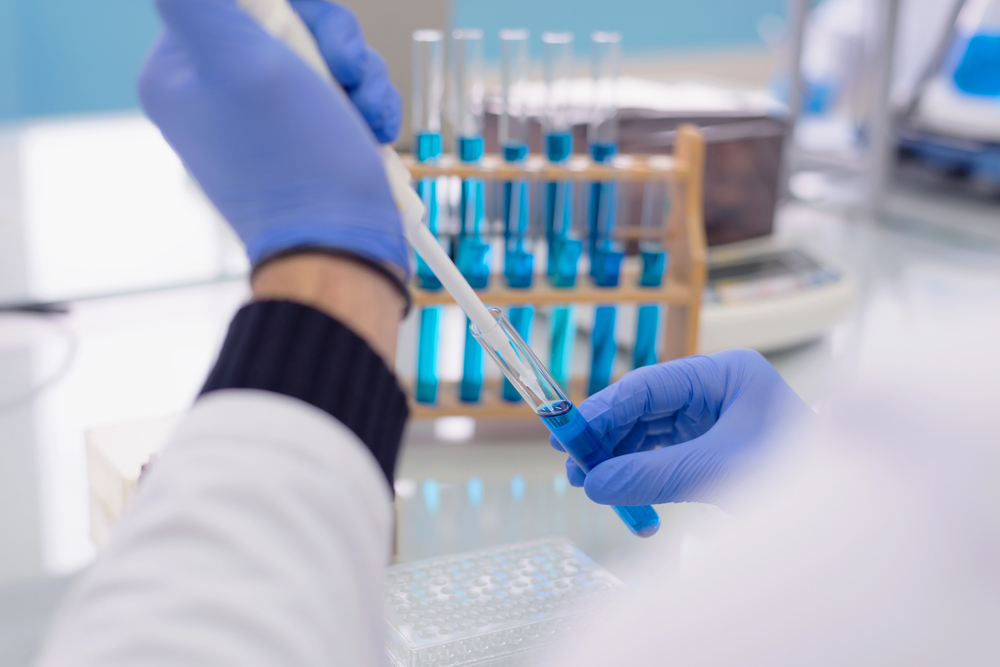 Young female Laboratory scientist working at lab with test tubes